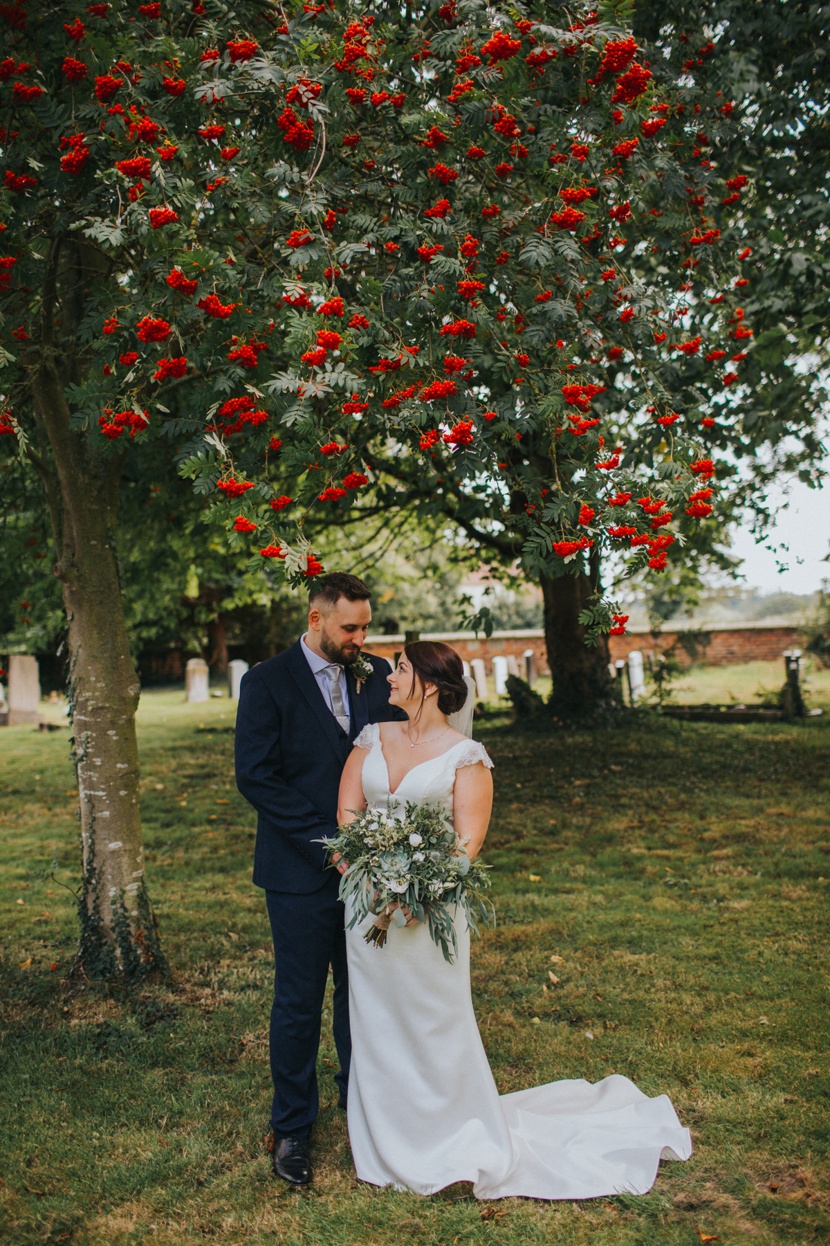bride and groom under berry tree