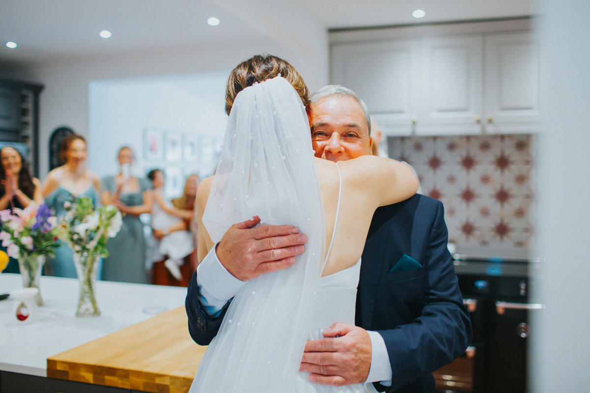 dad hugging daughter on wedding day