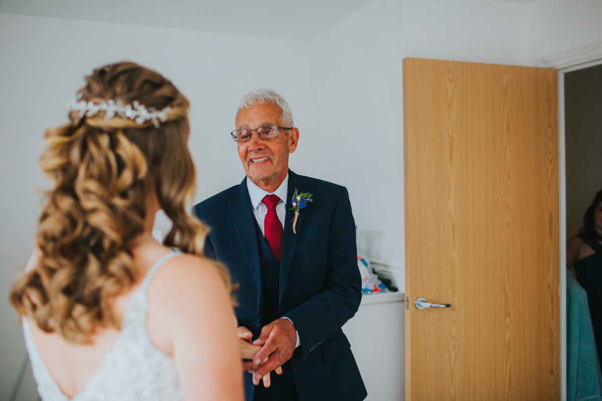 dad clasping bride's hand