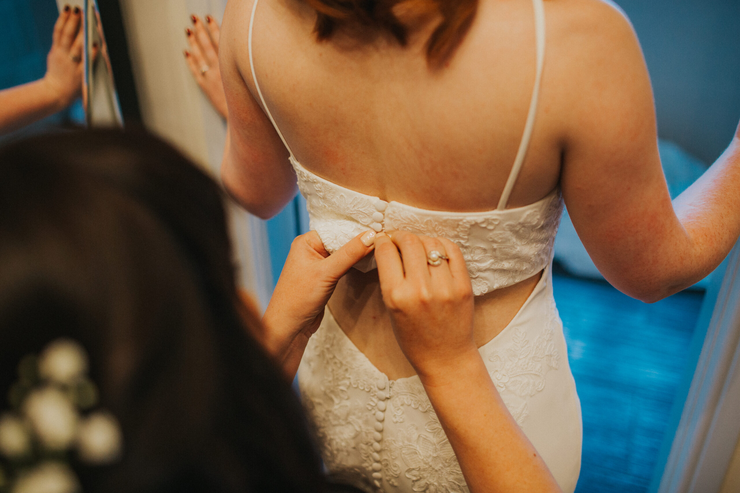 bride's dress being done up