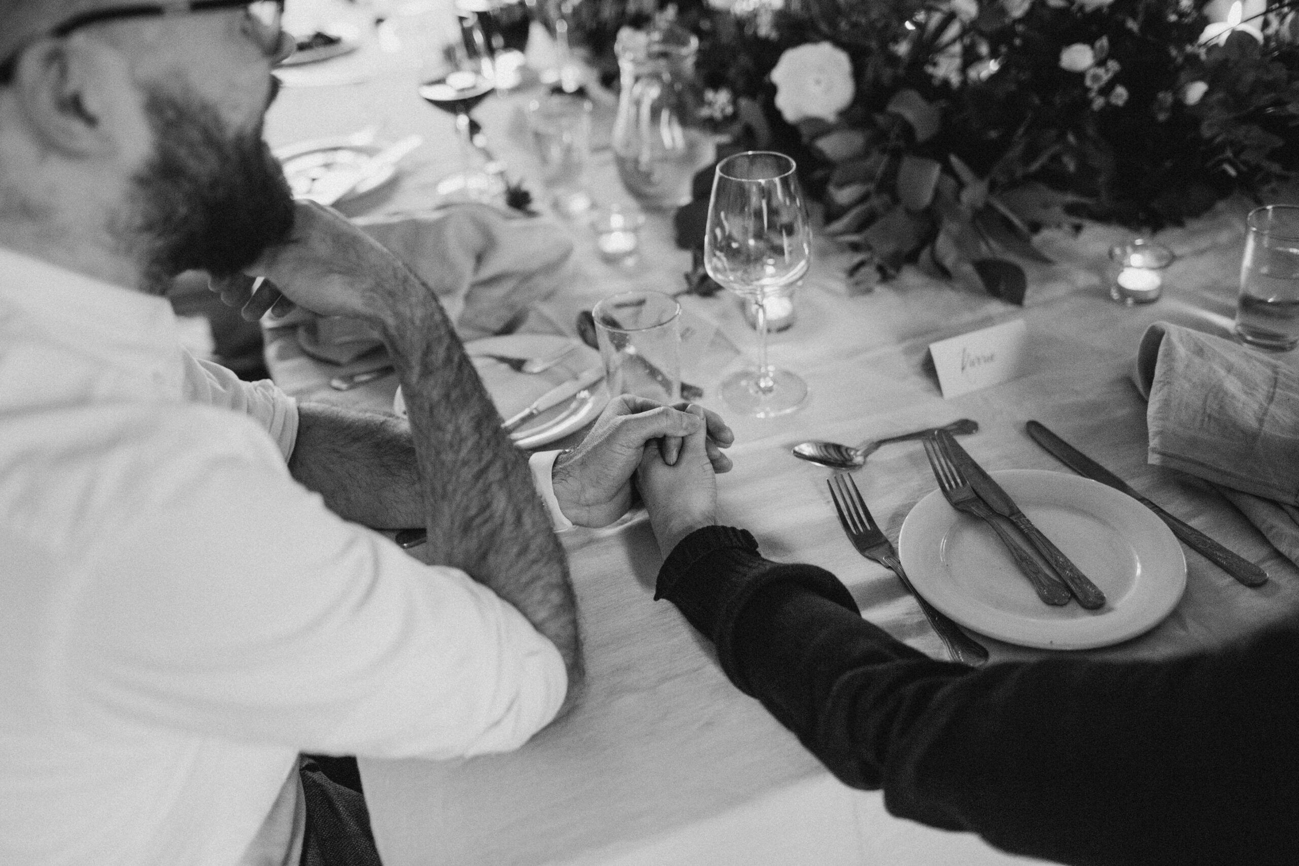 hands embracing on the dinner table
