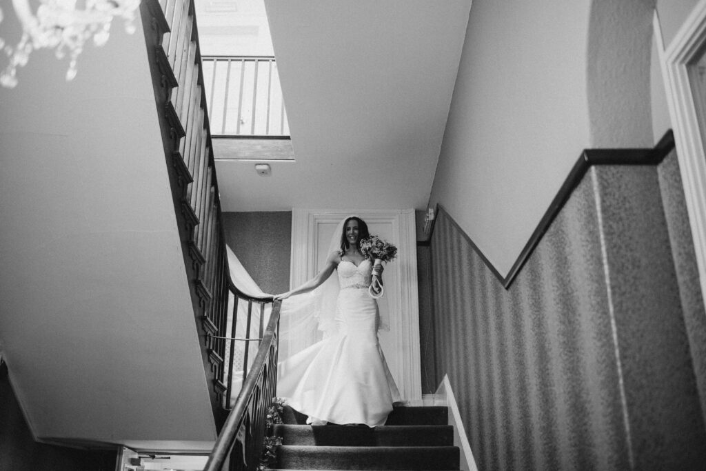 bride coming down the stairs at the wroxeter hotel
