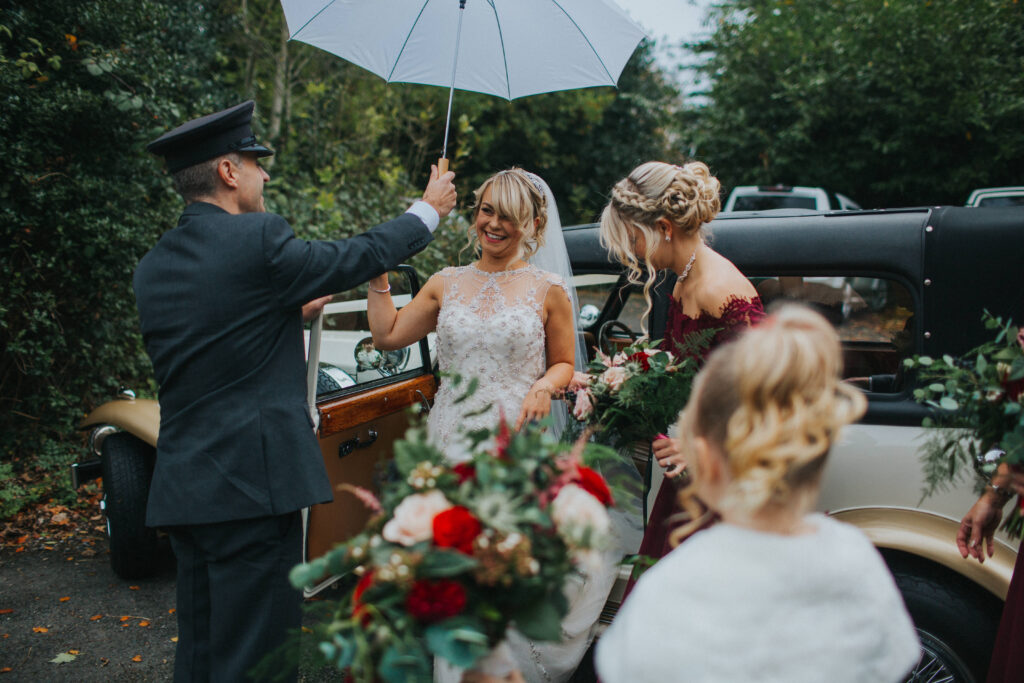 bride getting out of car in the rain