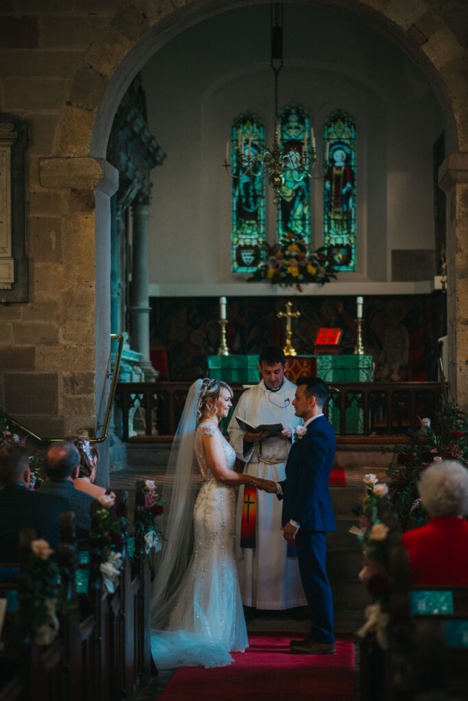 bride and groom exchanging vows in church