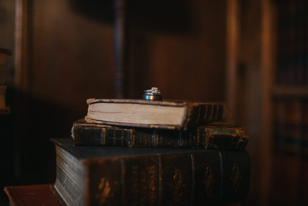 wedding rings on a stack of books