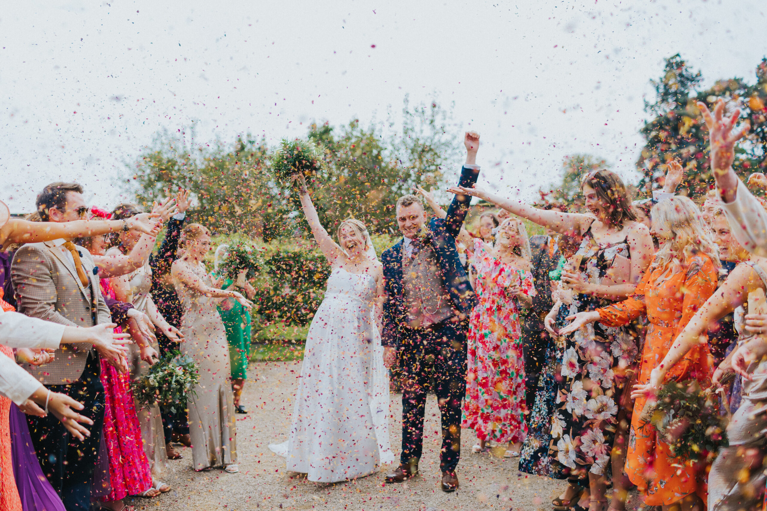 Bride and groom showered in colorful confetti