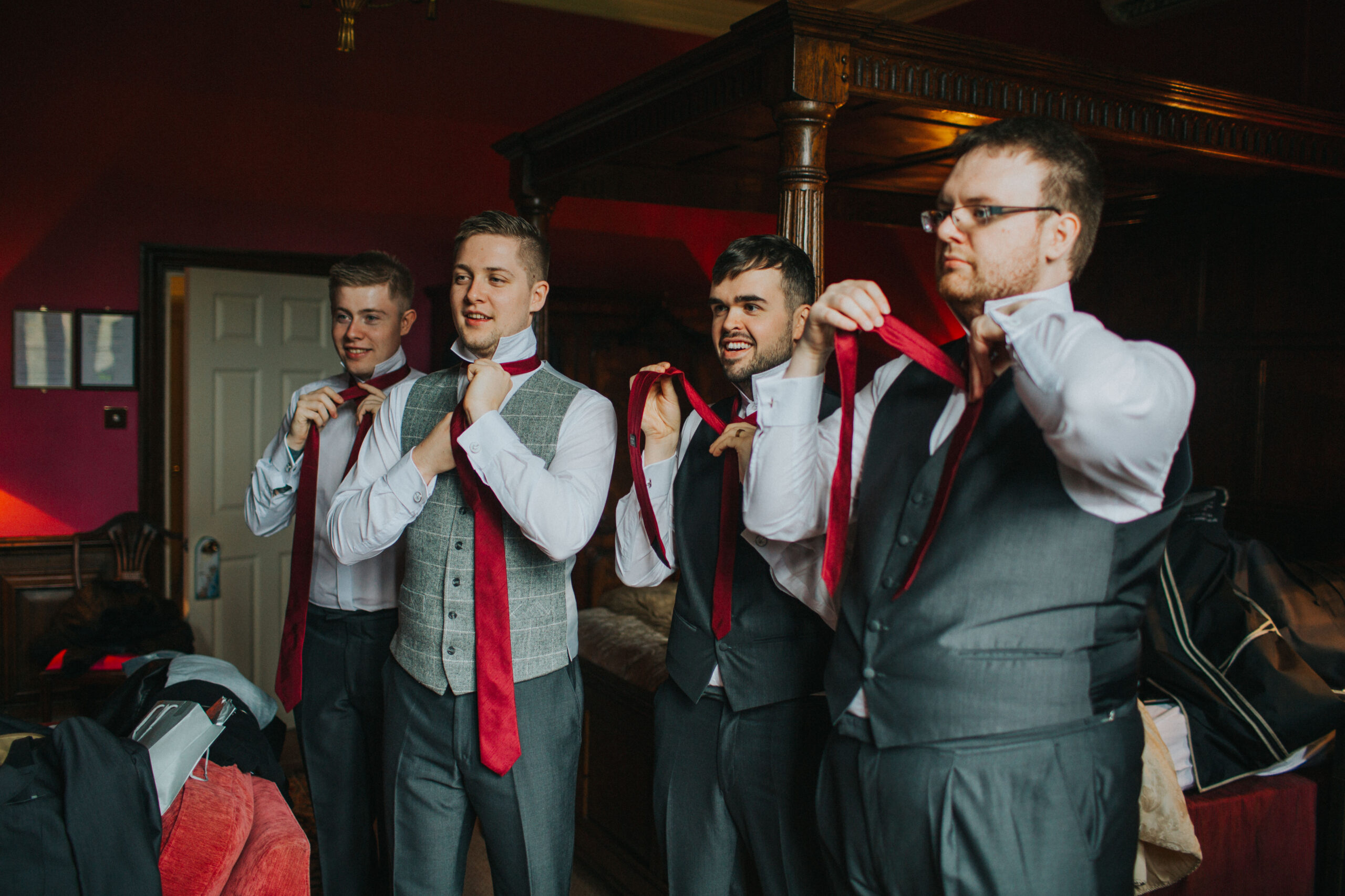 groom and groomsmen doing their ties