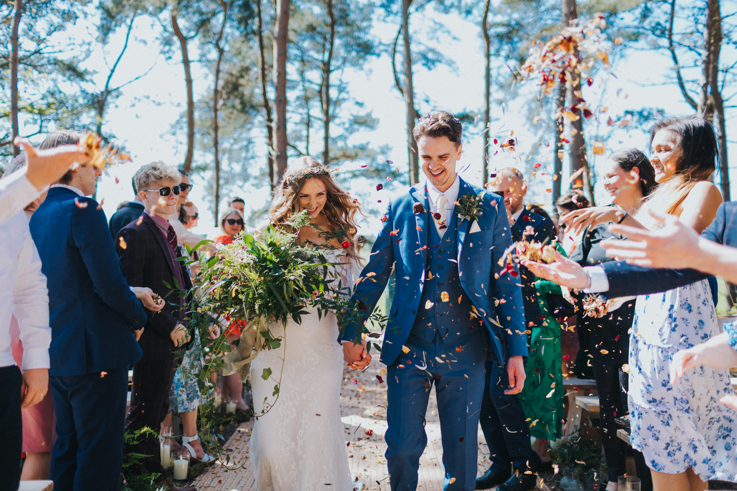 Guests cheering as confetti rains down on the newlyweds