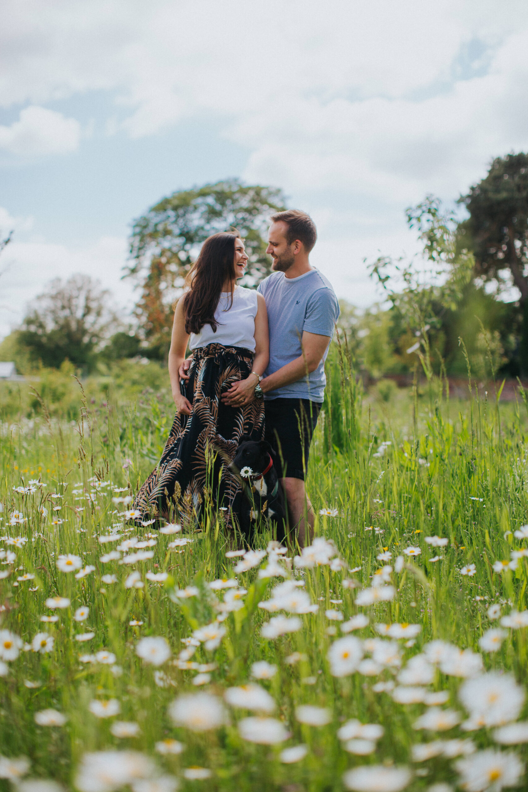 Artistic shot of the couple framed by nature during their session