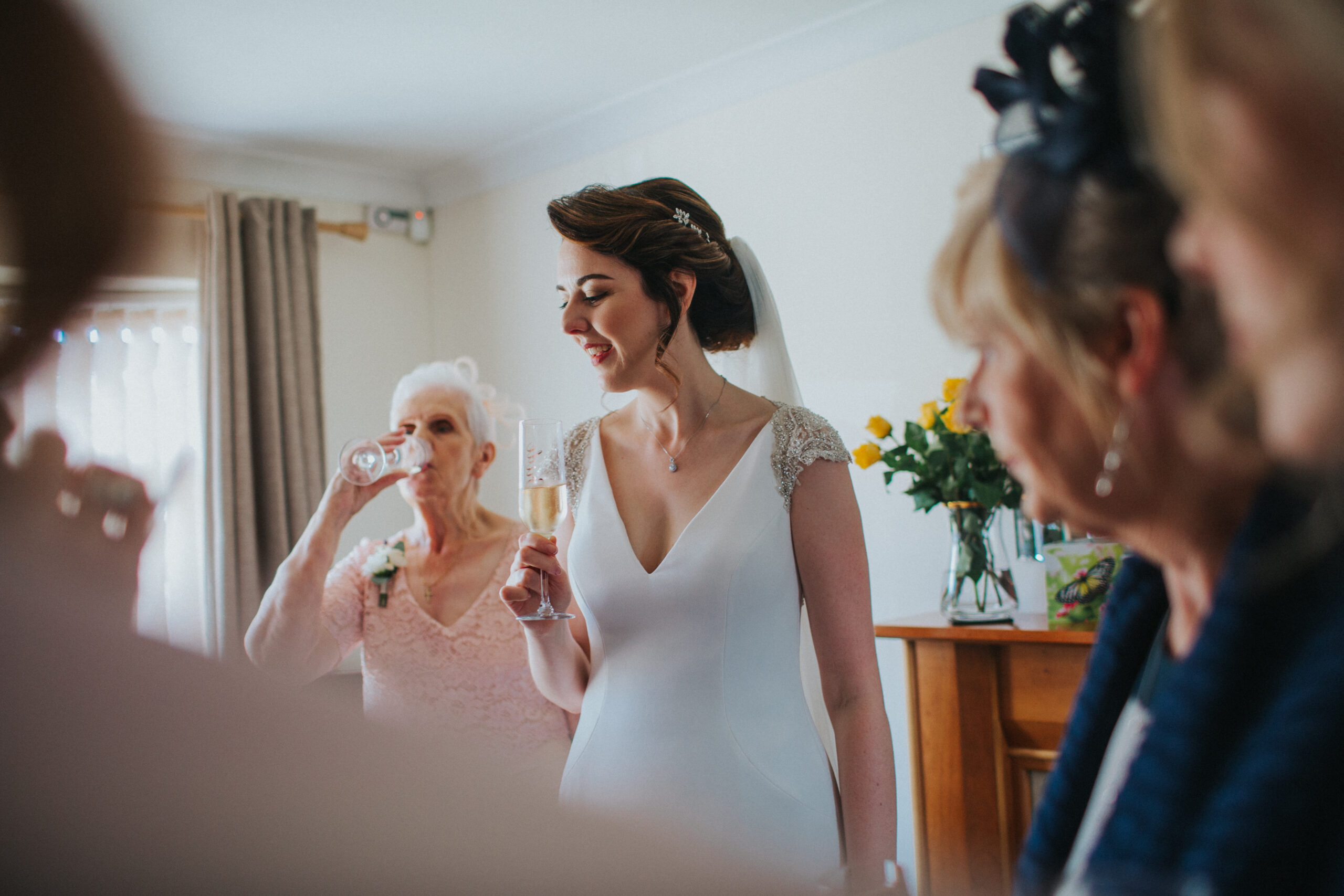 bride holding champagne glass, smiling