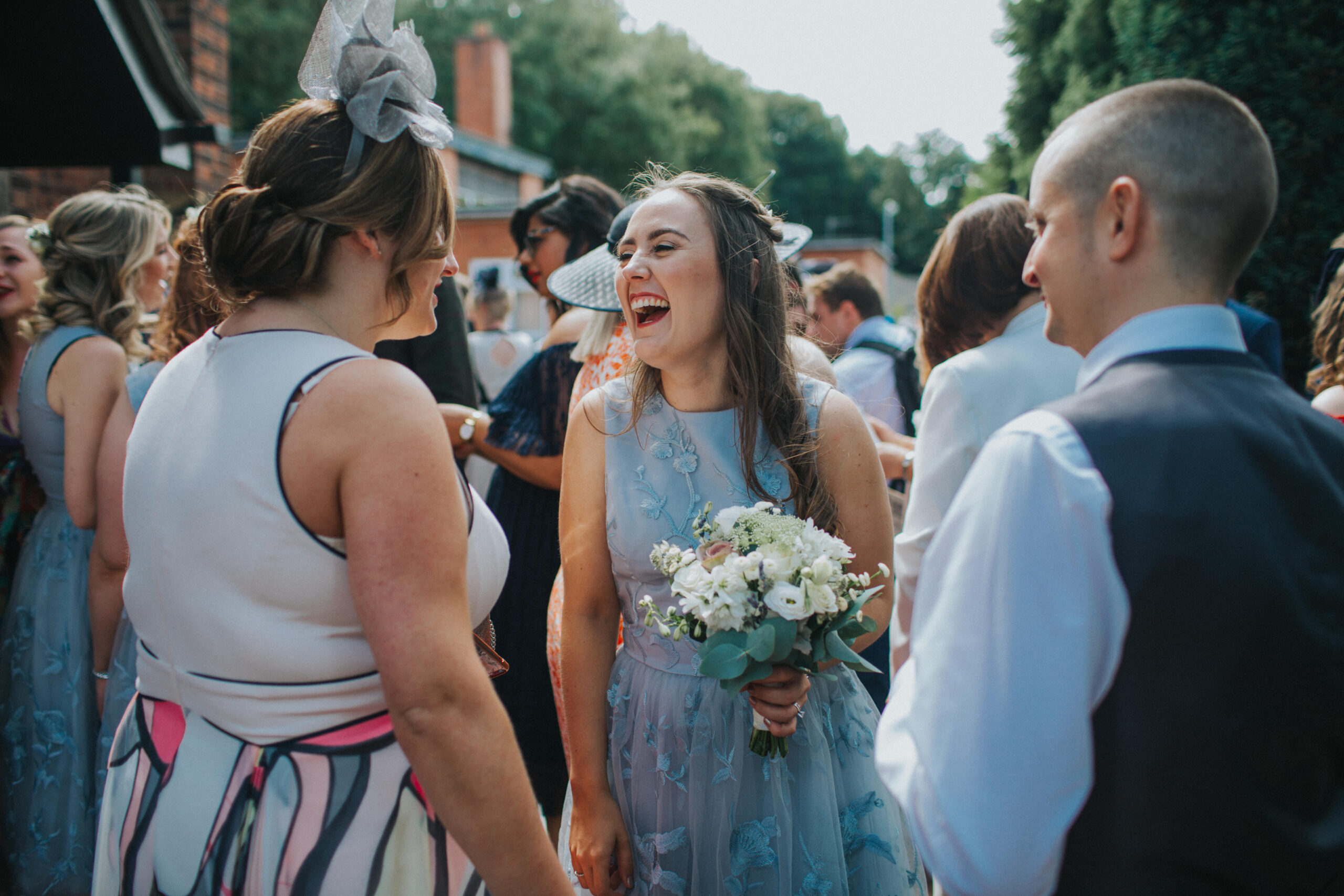 bridesmaid laughing outside church