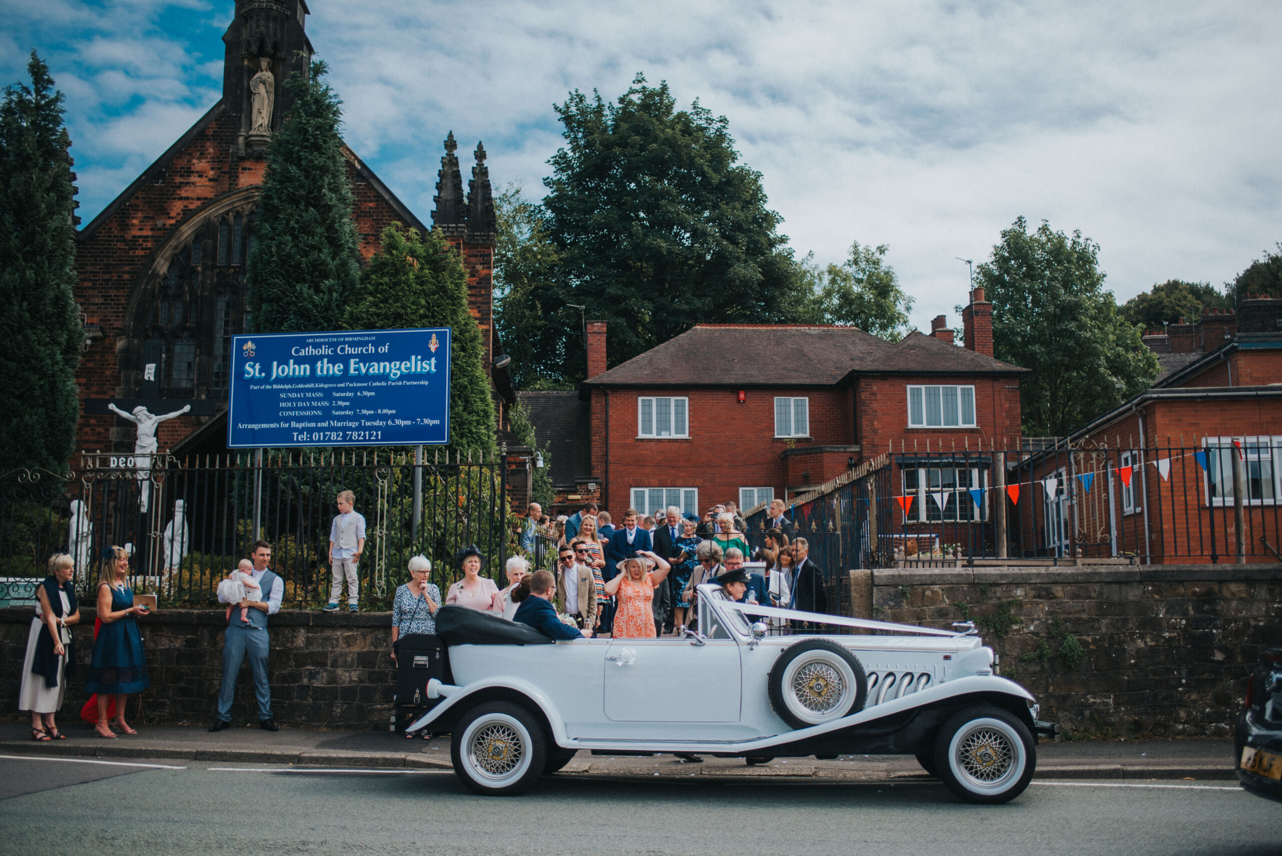 bride and groom leaving church in classic car