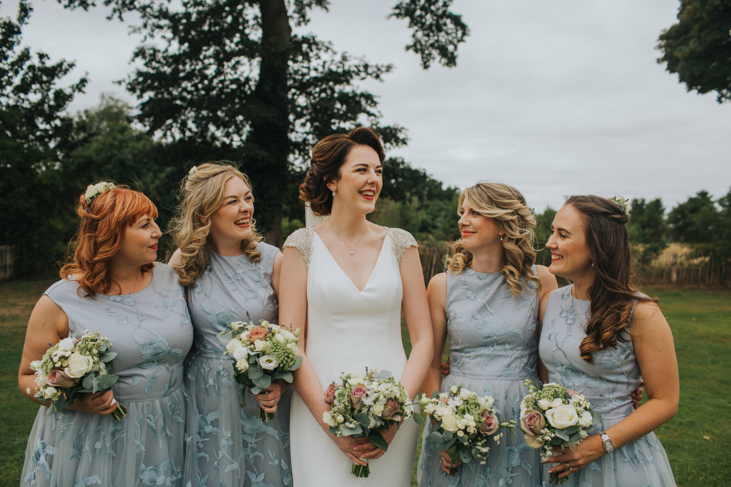 Bridal party laughter captured in the summer warmth