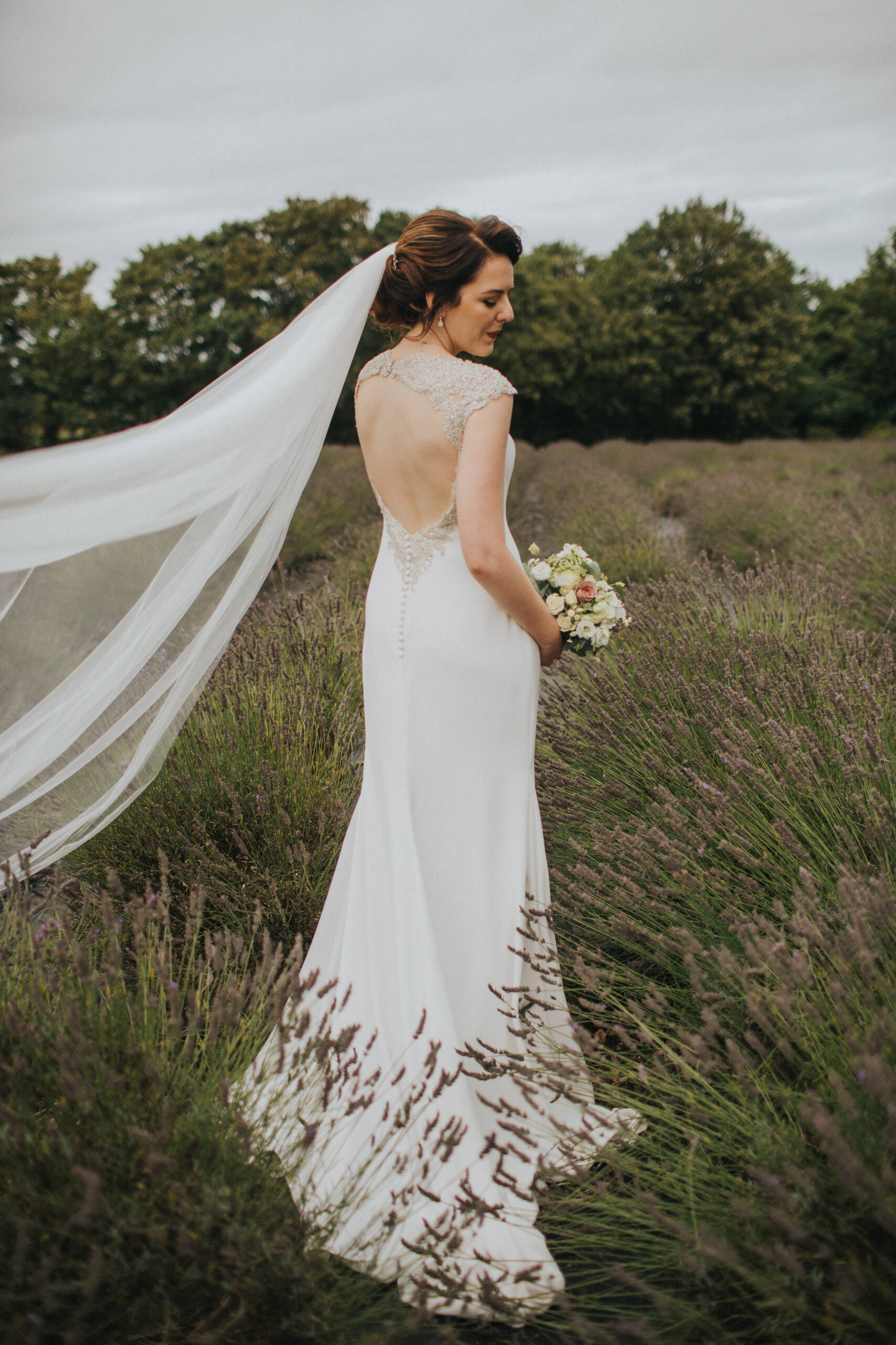 Bride's stunning gown complemented by the summer hues
