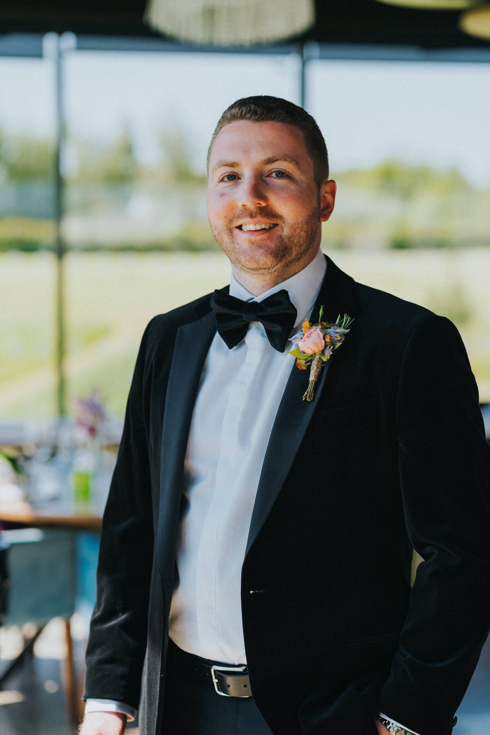 groom smiling at the camera