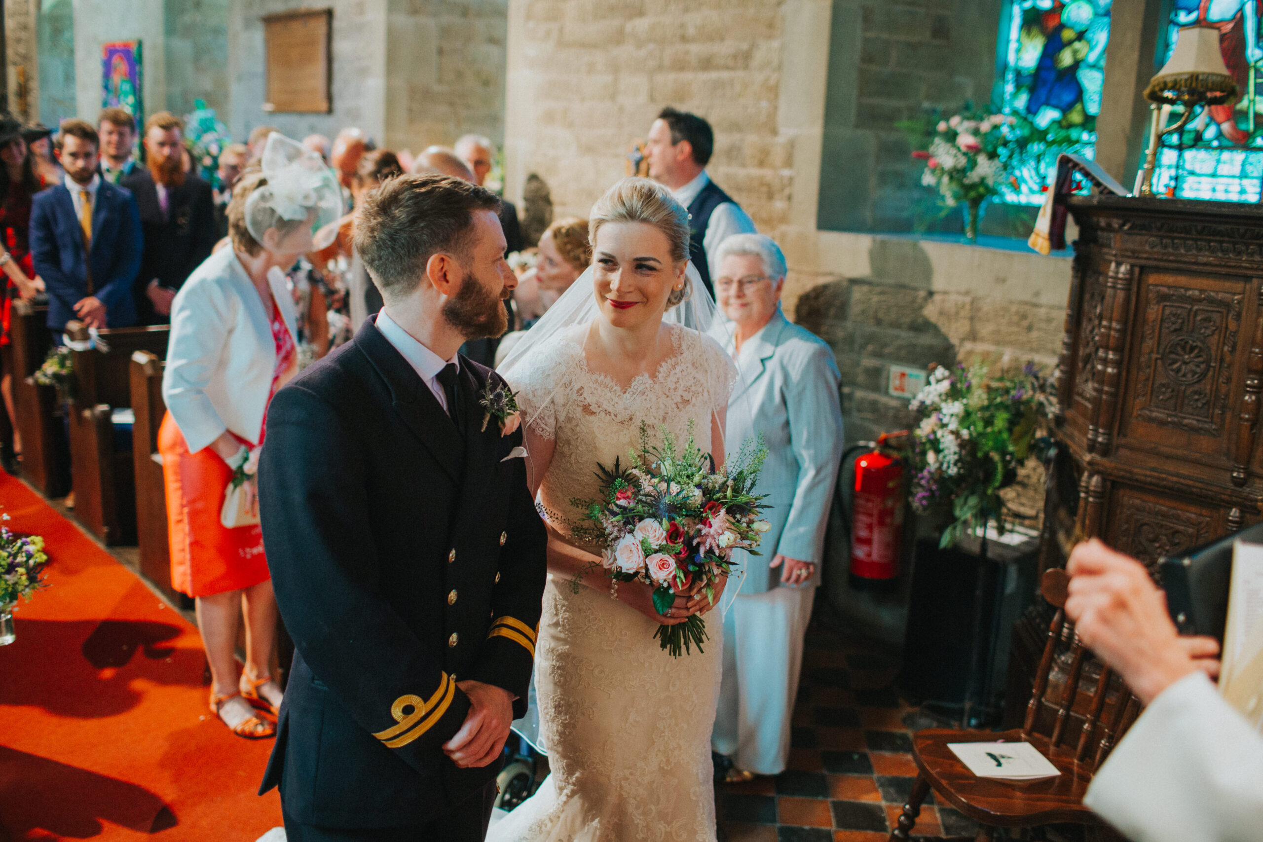 bride and groom at the top of the aisle in church