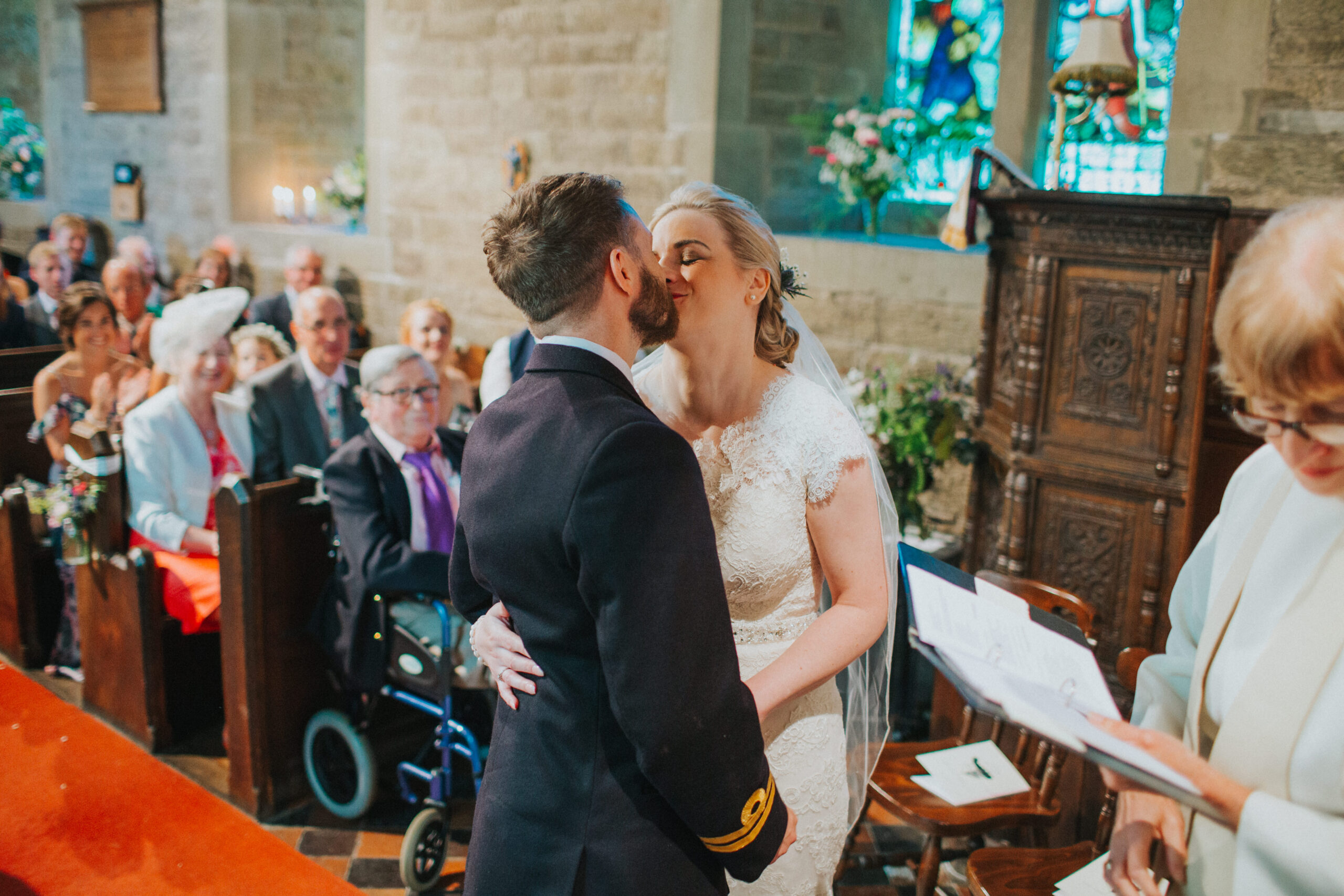 bride and groom first kiss in church