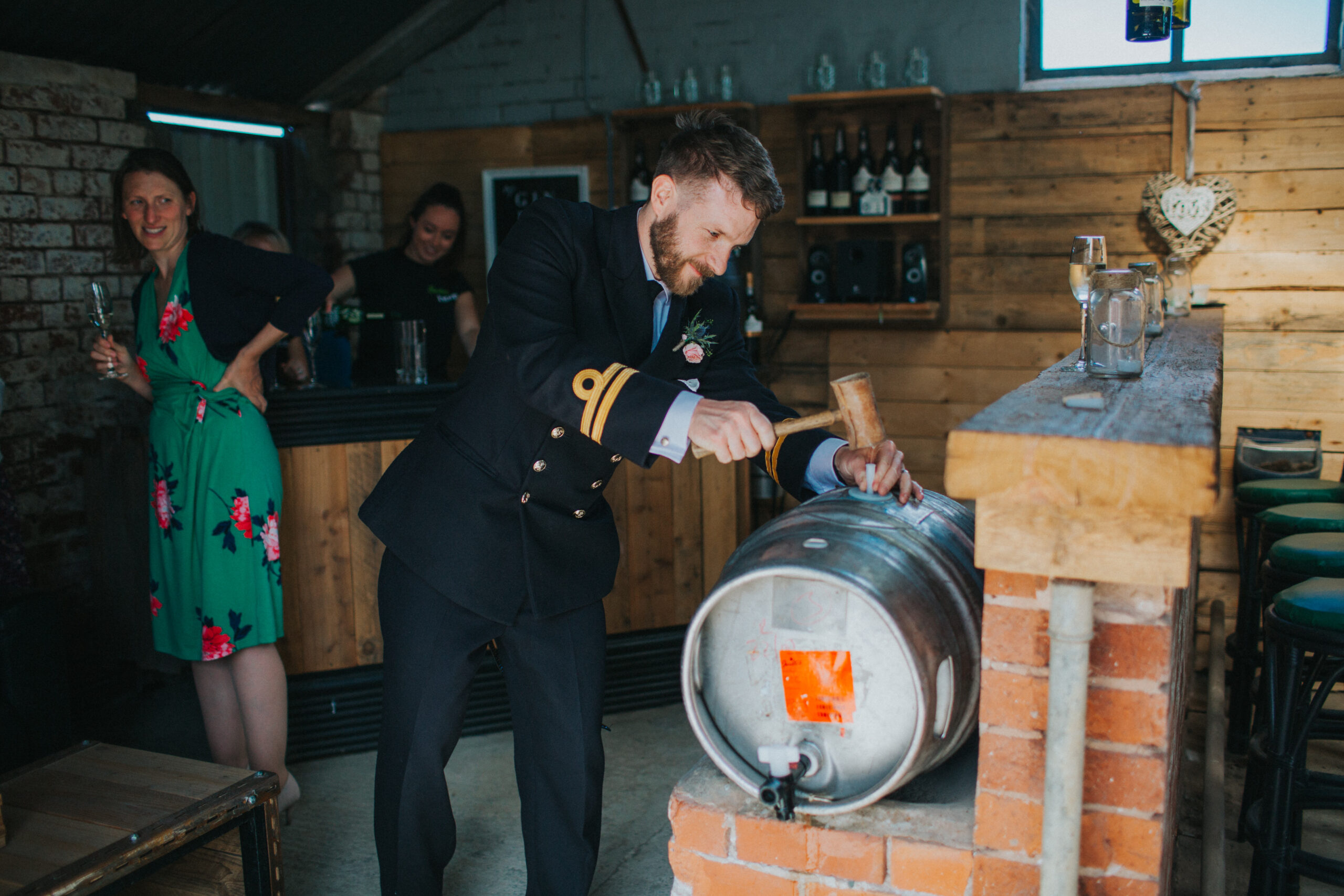 groom opening beer barrel