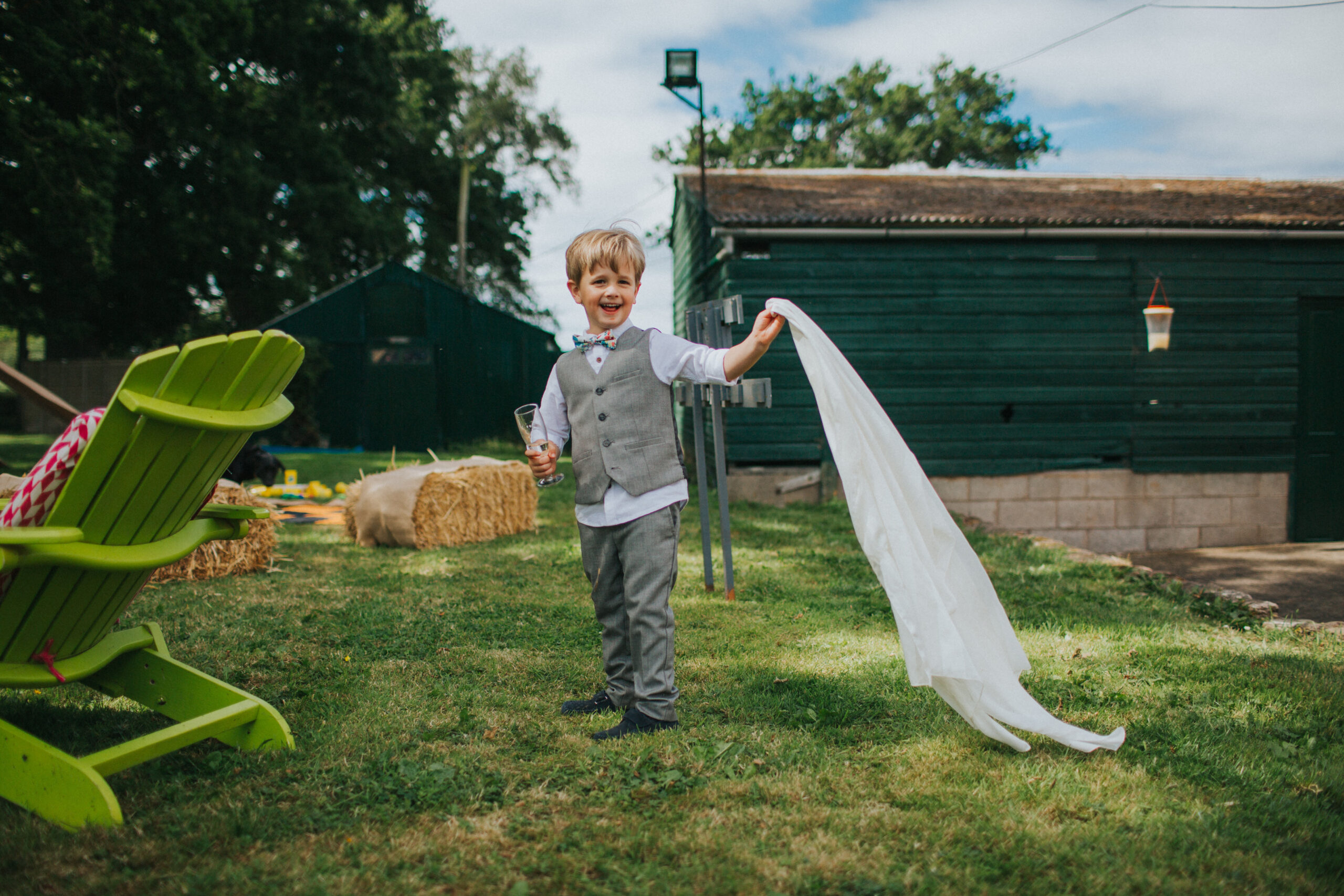 child at wedding holding veil