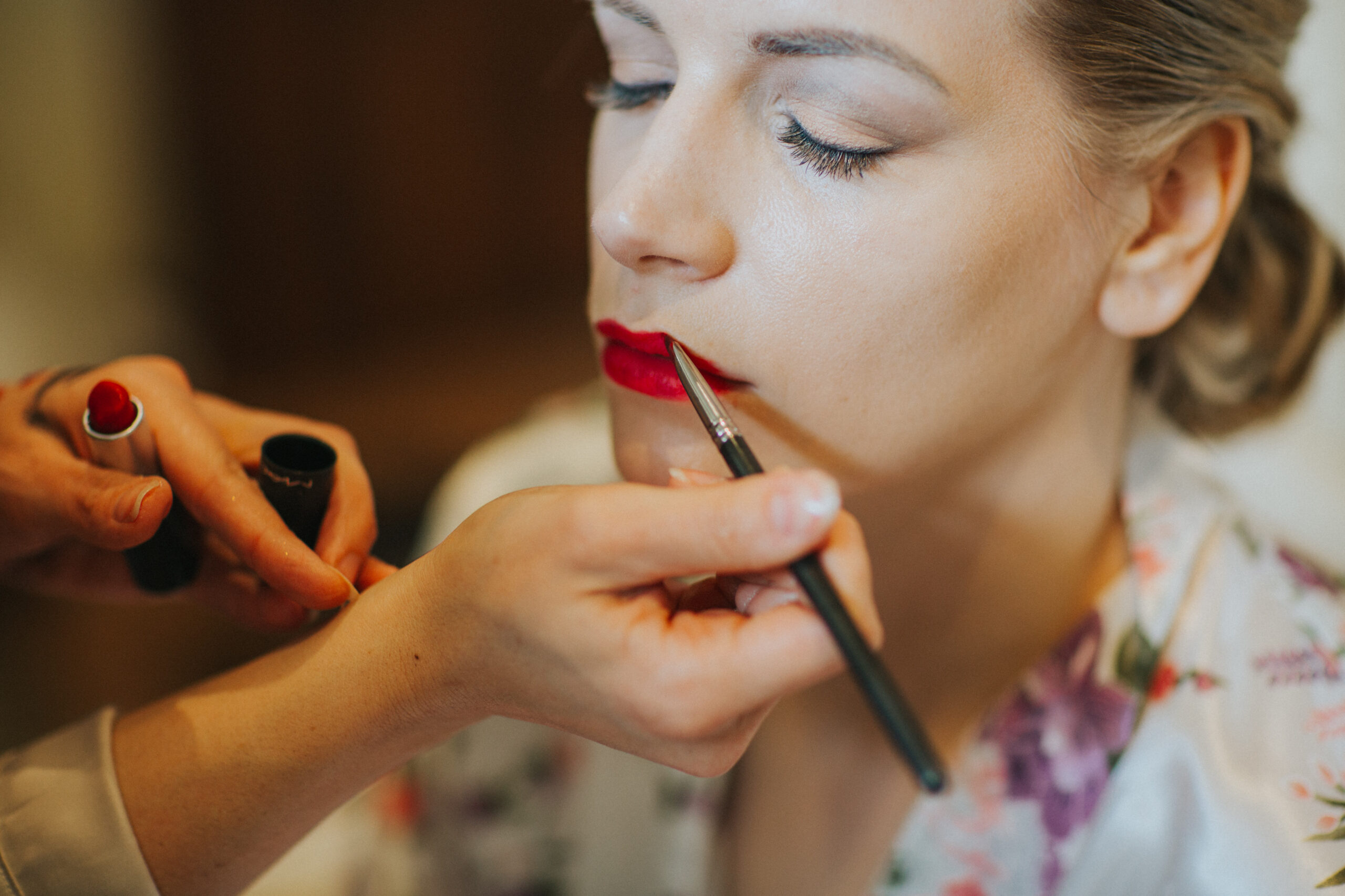 close up of bride having lipstick done