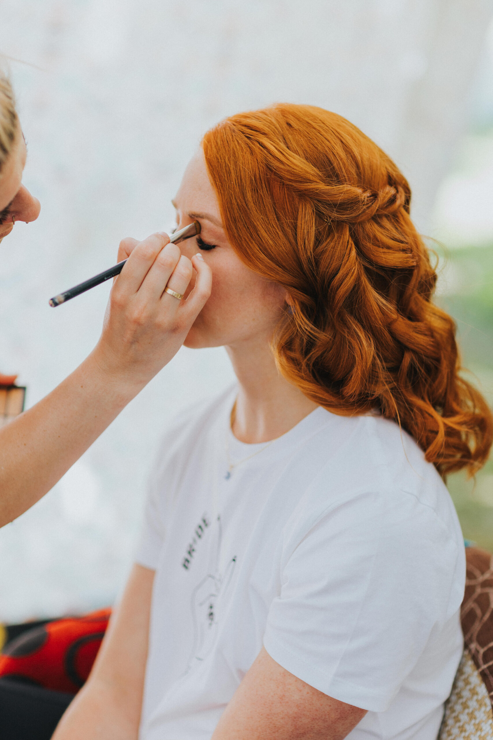 bride having make up done in tent