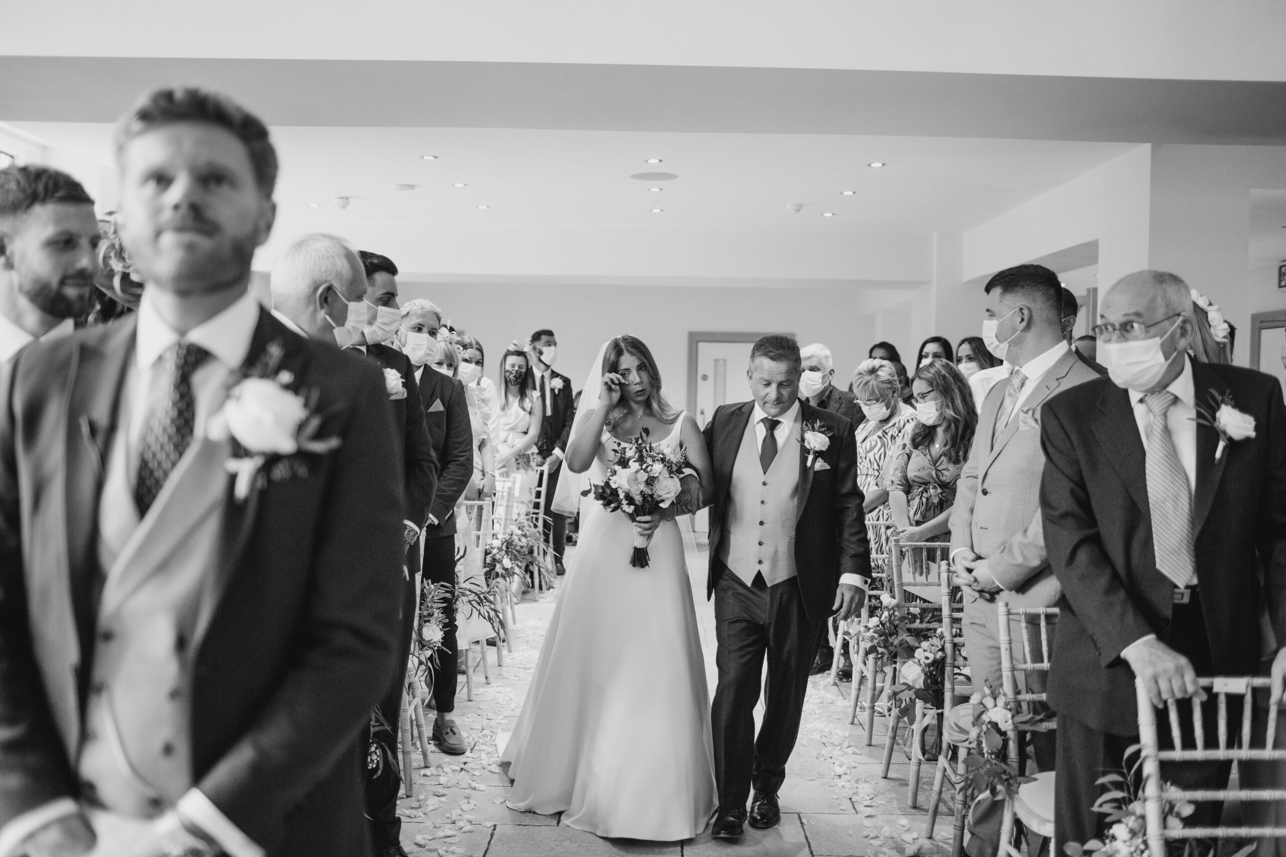 bride walking up the aisle in black and white at tyn dwr hall