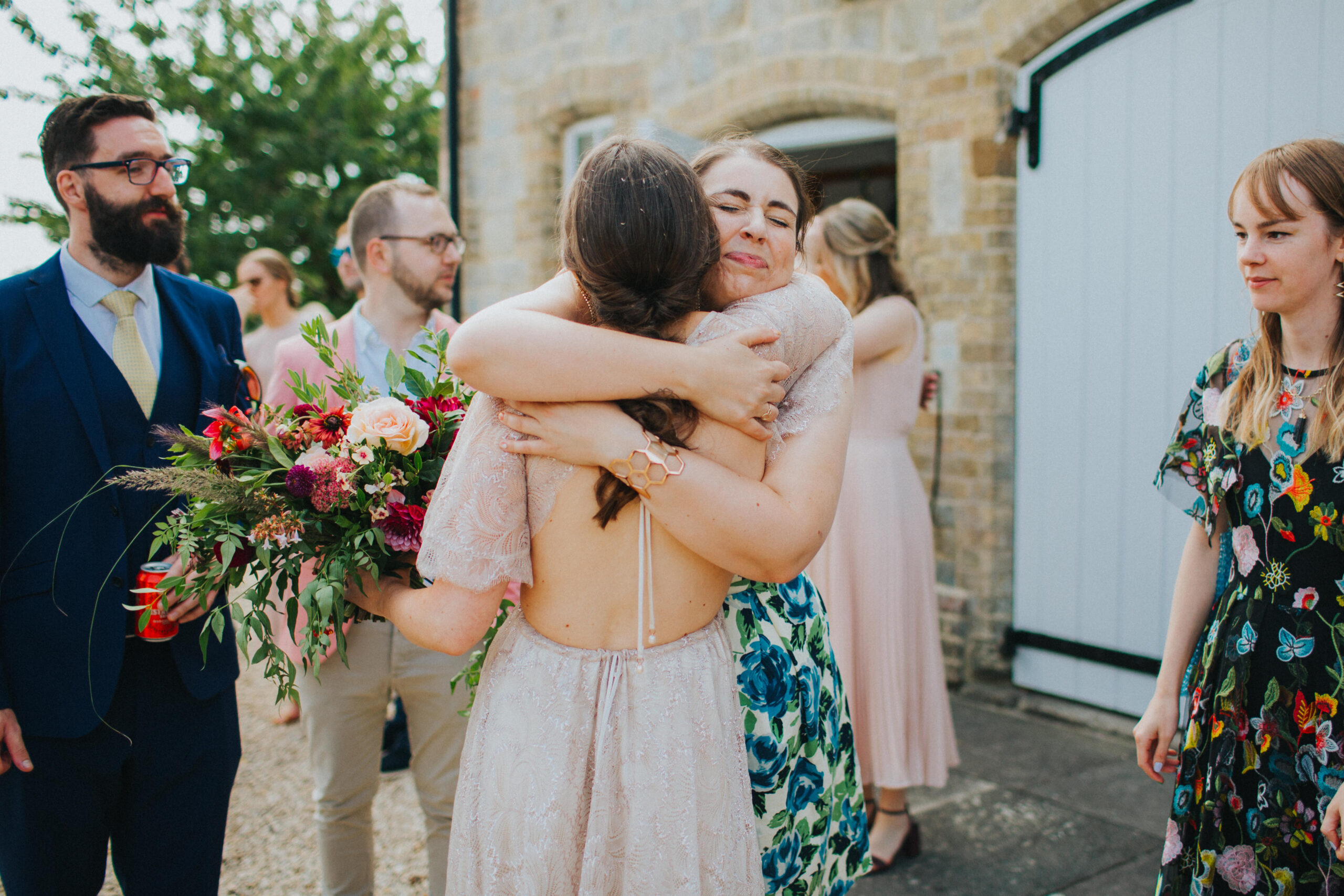 guest hugging bride